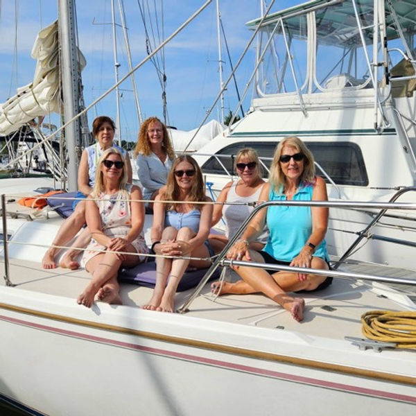 Group of women on the sailboat at the dock