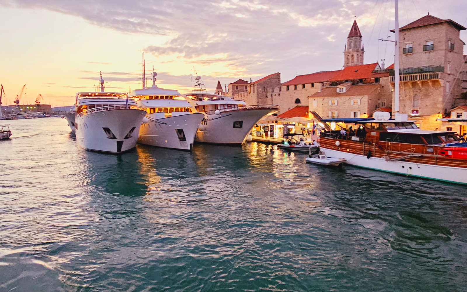 Harbor in Croatia at sunset with yachts at the quay